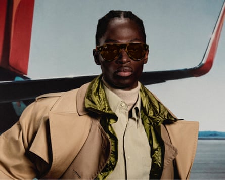 A man wears the Ray-Ban Meta (Gen 3) Aviators in front of an aeroplane wing.