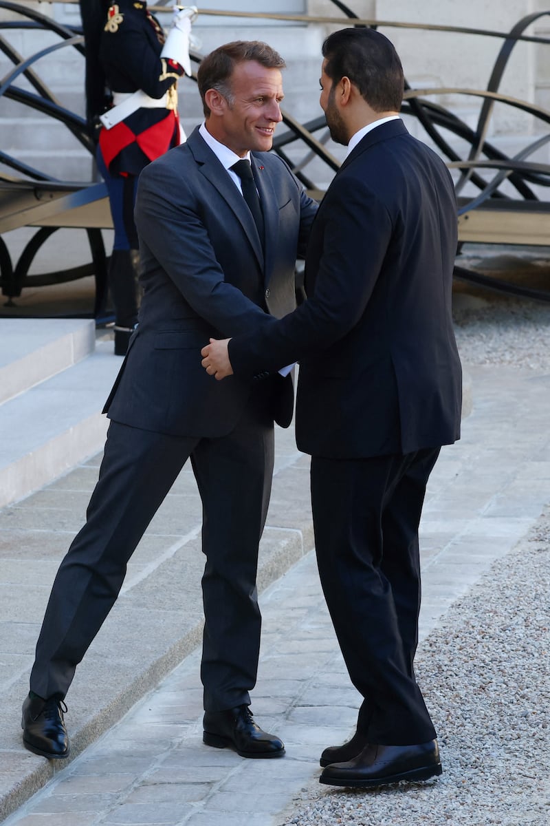 French President Emmanuel Macron, left, shakes hands with Iraqi Prime Minister Ali Al Zaidi at the Elysee Palace in Paris. Reuters