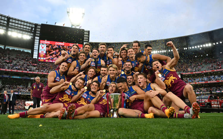 Brisbane Lions players celebrate winning the AFL Grand Final between the Sydney Swans and the Brisbane Lions at the Melbourne Cricket Ground, 2024.