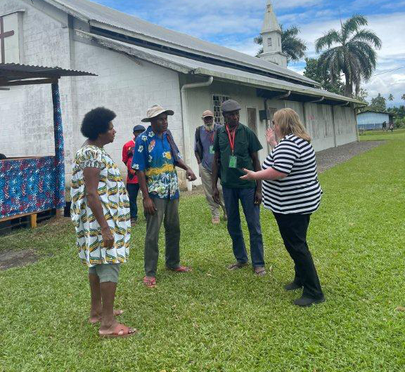 Tanya Olek (right) speaking with church leaders at the St Andrews Lutheran Church in Lae about the historical relation of the church and the World War II.