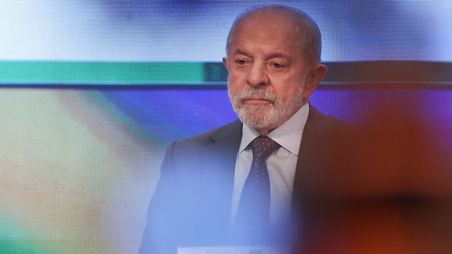 Reuters Brazil's President and candidate Luiz Inácio Lula da Silva sitting in front of a computerised screen while wearing a grey suit and purple tie.