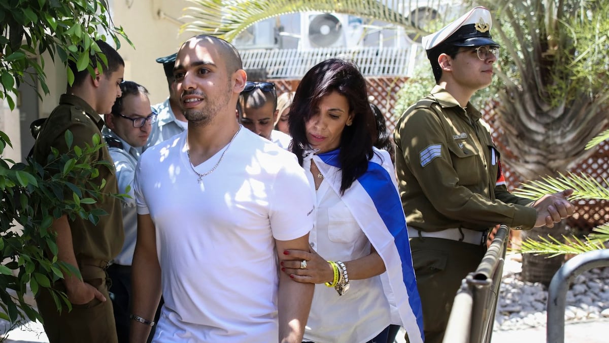 Israel's president pardons a combat medic whose shooting of a Palestinian attacker caused debate
