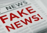 Folded newspaper with 'Fake News' written in bold red letters as a headline.
