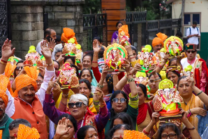 Shimla: Devotees carrying idols of Lord Ganesha dance during a Ganesh Chaturthi procession held as part of Ganesh Utsav celebrations, in Shimla, Himachal Pradesh, on Monday, September 14, 2026.