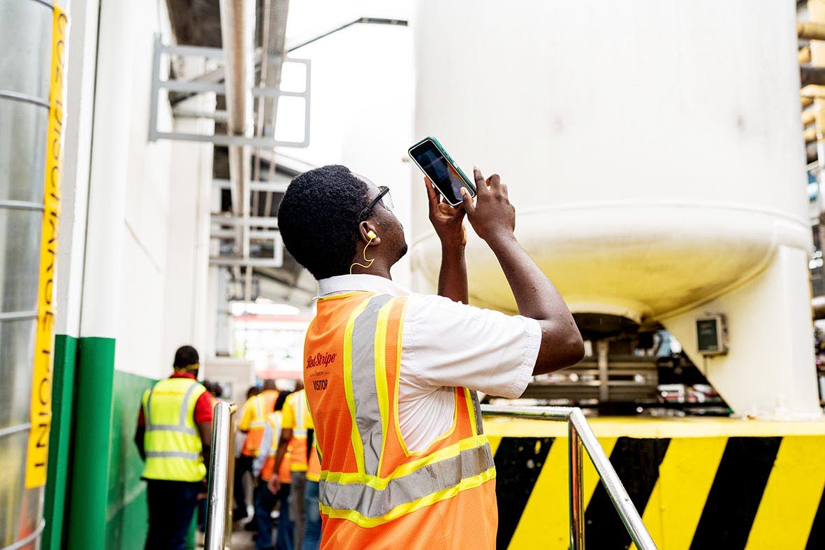 Courtenay Ferguson, one of the competitors for WorldSkills Jamaica captures photographs of machinery as participants explore the technology and equipment used in modern manufacturing.