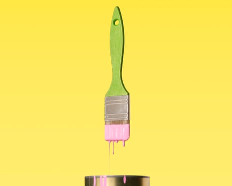 Pink paint dripping into a tin from a green-handled paint brush.