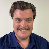 A man looking at the camera in a blue shirt
