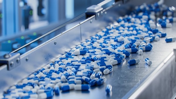 Capsules on a conveyor belt in a pharmaceutical factory