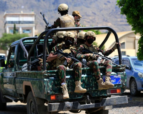 Houthi armed forces ride in a pickup truck patrolling the streets of Sanaa