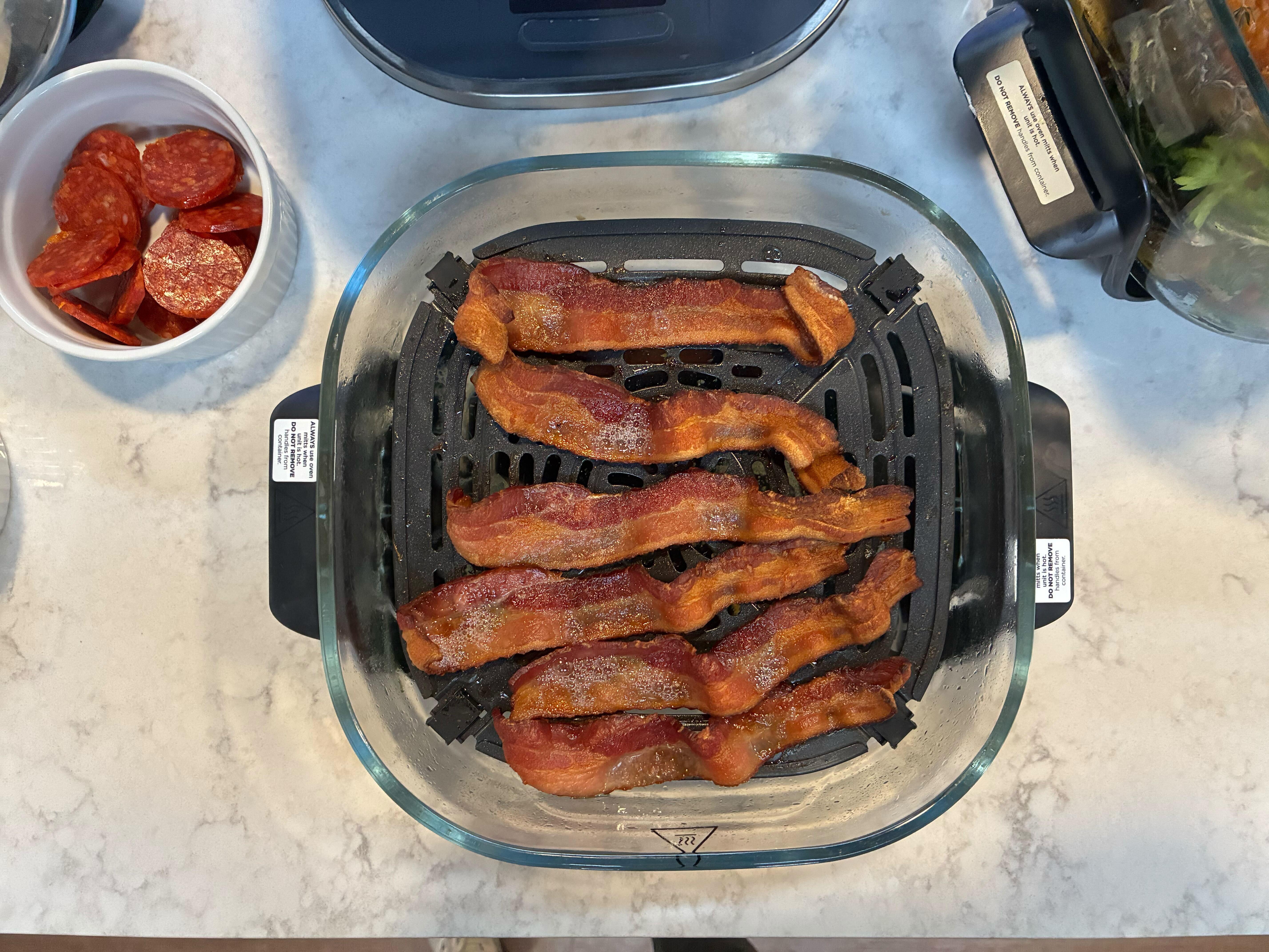 bacon in an air fryer shot from above.