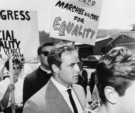 Marlon Brando marches with members of the Congress of Racial Equality to protest an all-white housing area in Torrance, California on 1 January 1963.