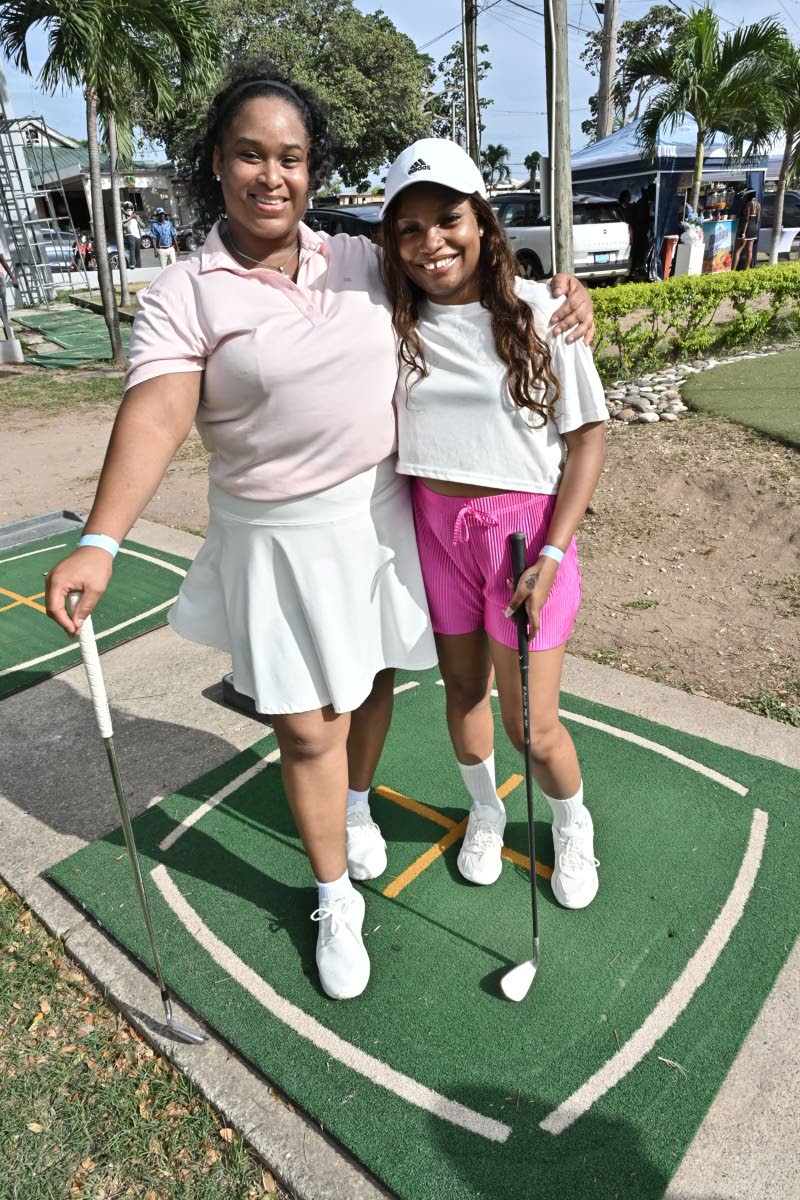 Abigail McKenzie (left), quality assurance technician, and Risk Associate Akilah Williams bring a playful pink-and-white palette to the course.